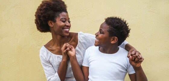 Happy young mother having fun with her child - Mom playing and dancing with his son - Family lifestyle, motherhood, love and tender moments concept - Focus on mama face