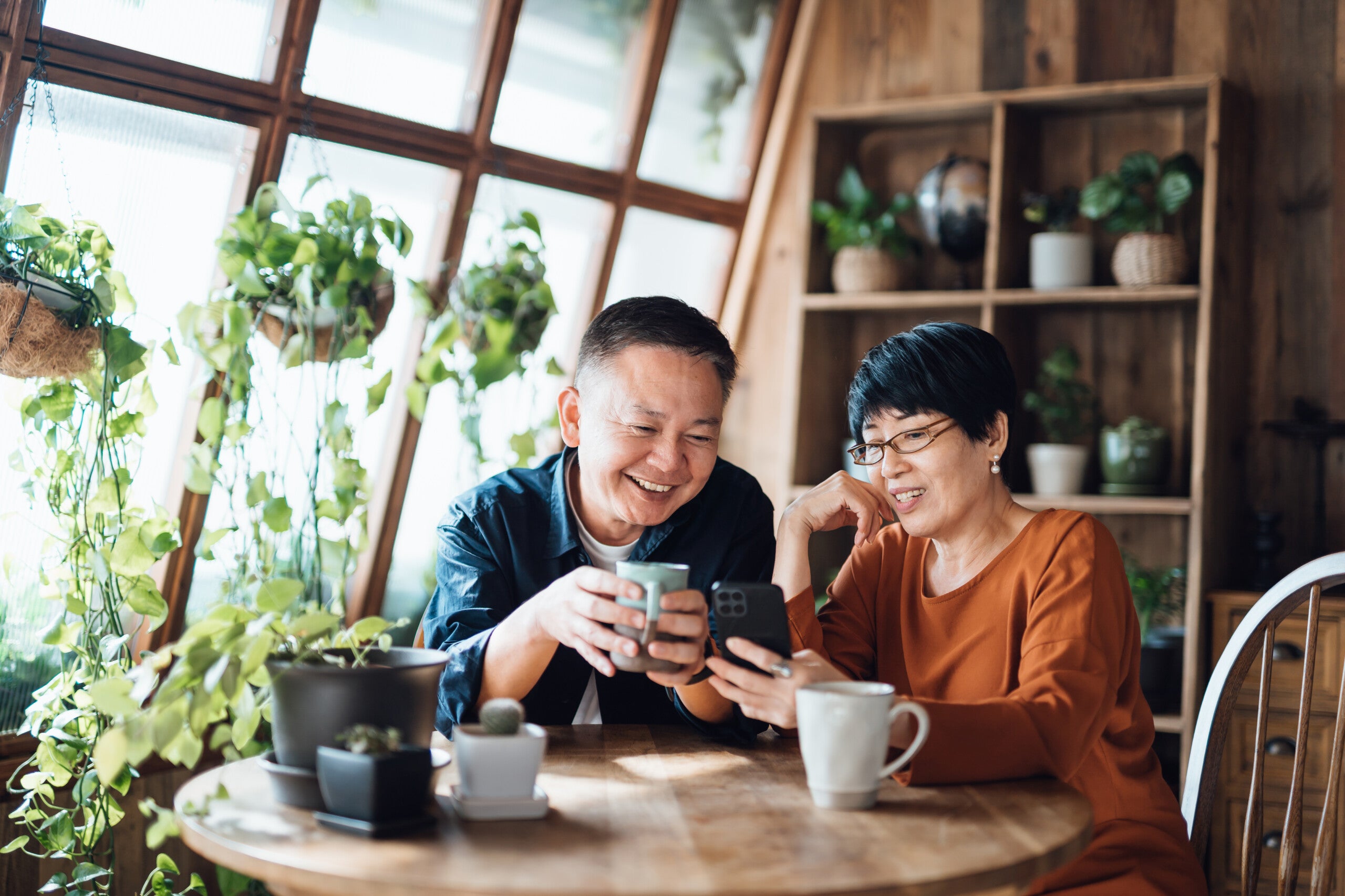 happy senior couple looking at their bank account after rewards