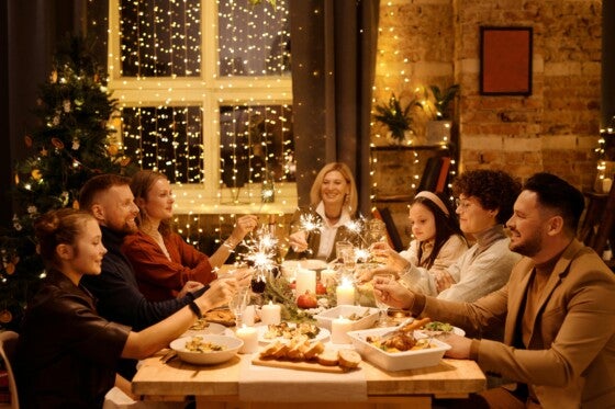 Family celebrating with sparklers over holiday meal