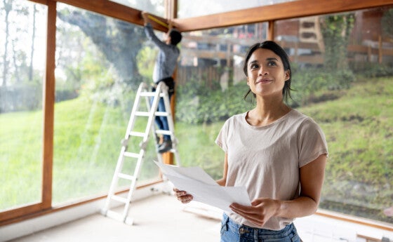 Latina homeowner overseeing renovations